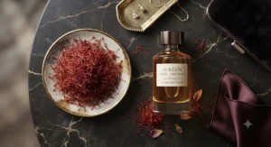 Flat lay illustration of natural saffron threads beside a sophisticated evening wear perfume bottle.